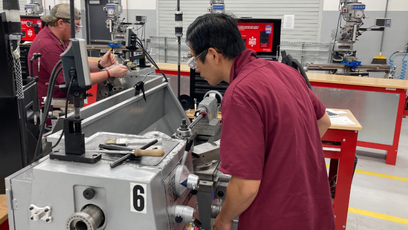 Image of two students working in the GWCC Machining Lab