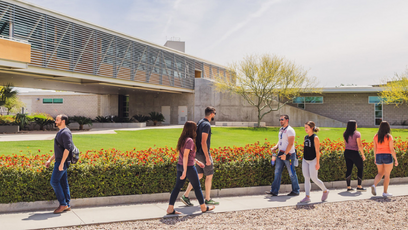 Image of seven students walking across campus in different directions
