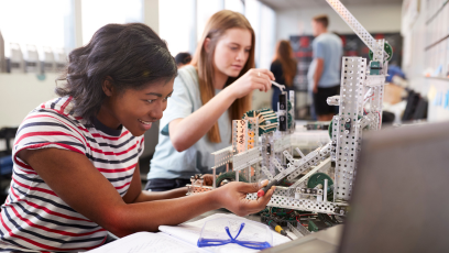 An image of two female students working together on an engineering project