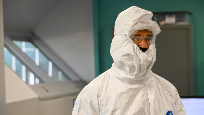 A semiconductor student wearing a clean room bunny suit