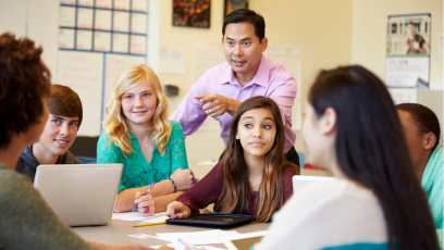 A stock image of high school students working in a small group with a teacher
