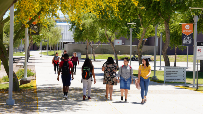 A photo with eight South Mountain Community College students walking across the campus.