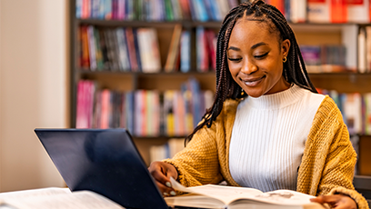 Image of female student studying at a laptop computer.