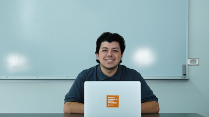 An image of a happy college using a laptop