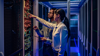 Image of two people in a computer server room