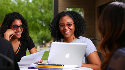 Image of smiling women working on laptops