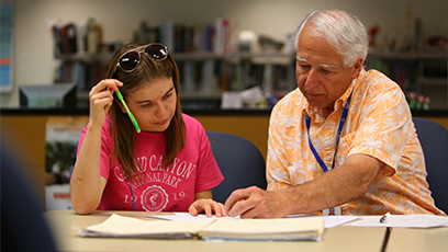 A male teacher working one-on-one with a female student
