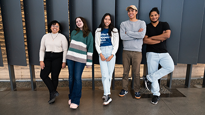 A group of five Maricopa Community Colleges students standing in front of levered panels