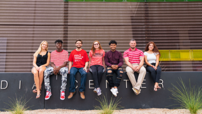 An image of Glendale Community College students sitting in a row outside