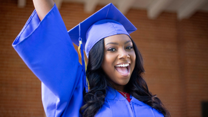 An image of a Maricopa Community Colleges female graduate wearing a graduation cap and gown