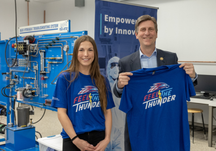 Congressman Greg Stanton visited Mesa Community College's nursing and advanced manufacturing labs. He's pictured with a MCC student hold a MCC T-shirt.
