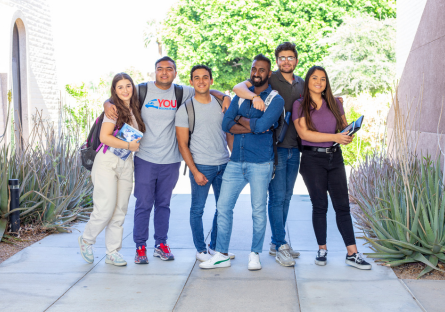 A photo with six college students standing together on a college campus