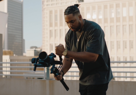 Shawn Deloney is holding a camera shooting b-roll