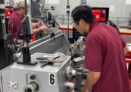 Image of two students working in the GWCC Machining Lab