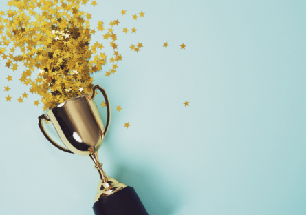 Image of a trophy with stars on a light blue background
