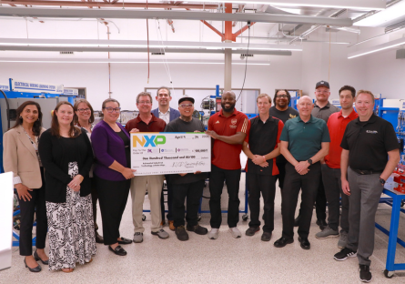 NXP, Mesa Community College and Estrella Mountain Community College representative holding a large NXP check for $100,000.
