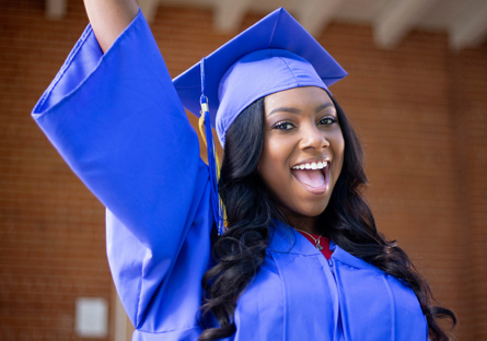 An image of a Maricopa Community Colleges female graduate wearing a graduation cap and gown