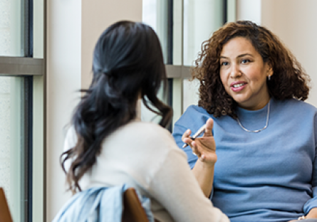 A stock image of two women talking to each other.