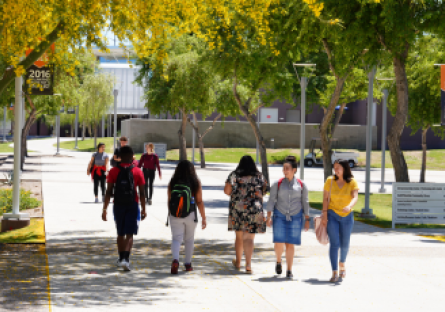 A photo with eight South Mountain Community College students walking across the campus.