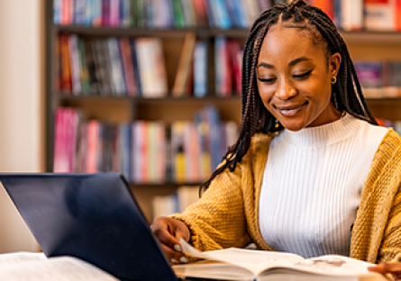 Image of female student studying at a laptop computer.