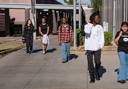 Five SMCC students walking across the campus