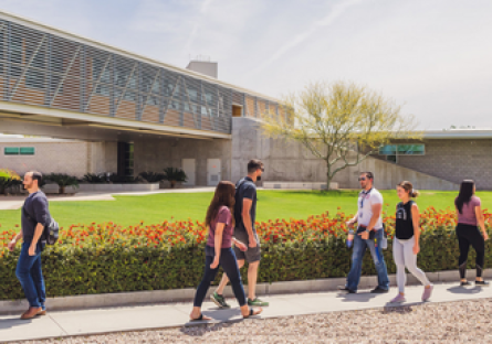 Image of seven students walking across campus in different directions