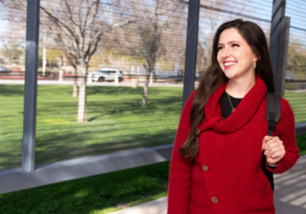 Image of a woman wearing a red sweater and backpack