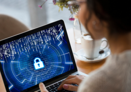 Image of a woman holding a tablet with a cybersecurity lock