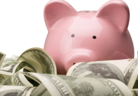 Image of a pink piggy bank with dollar bills