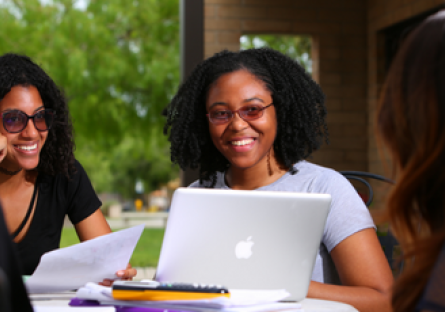 Image of smiling student  working on laptop computer