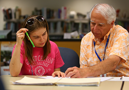 A male teacher working one-on-one with a female student