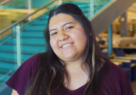 An image of a smiling female HSI EXCELlence student wearing a maroon shirt 