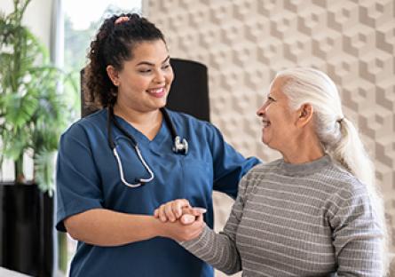 An image of a woman healthcare worker with an elderly woman.