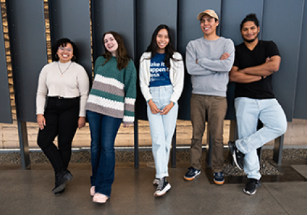 A group of five Maricopa Community Colleges students standing in front of levered panels