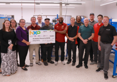 NXP, Mesa Community College and Estrella Mountain Community College representative holding a large NXP check for $100,000.