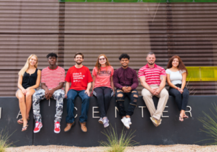 An image of Glendale Community College students sitting in a row outside