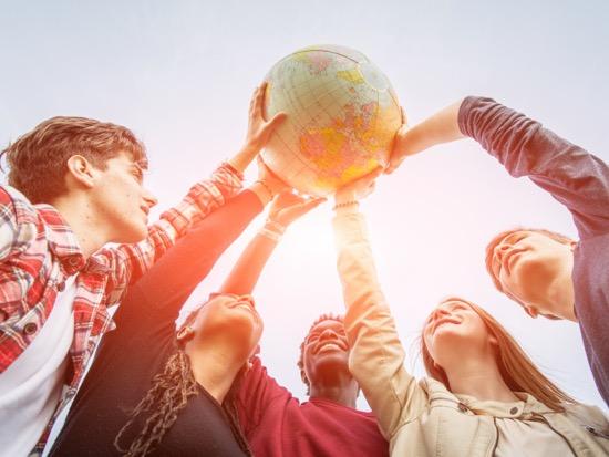 Students holding a globe